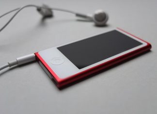 Free app to download and listen to music Headphones resting on a desk beside a music player