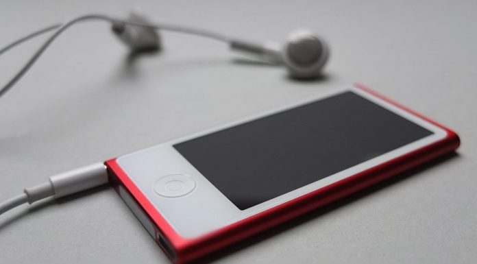 Free app to download and listen to music Headphones resting on a desk beside a music player