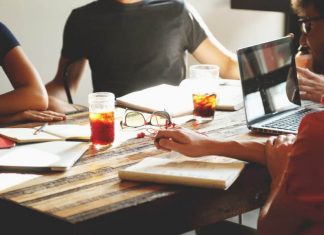 Start Your Own Business Team meeting around a table with coffee and notes