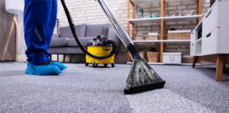 How To Clean Your Costly Woolen Carpet? Woolen area rug being cleaned with a brush