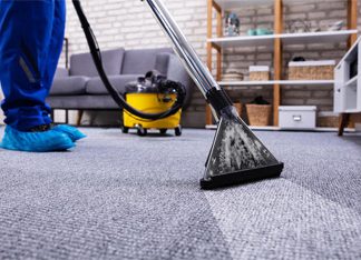 How To Clean Your Costly Woolen Carpet? Woolen area rug being cleaned with a brush