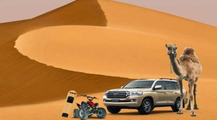 Morning, Night & Overnight Abu Dhabi Desert Safaris Four wheel drive vehicle crossing golden desert sand dunes